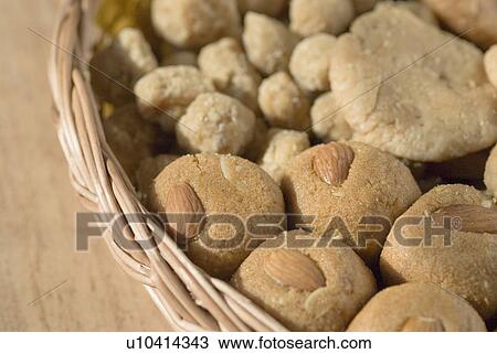 Stock Image - Close-up of sweets and cookies in a wicker basket. Fotosearch
