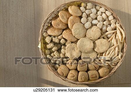 Stock Image - Close-up of sweets and cookies in a wicker basket. Fotosearch