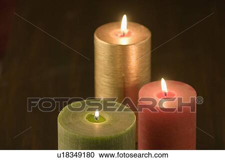 Close-up of three burning candles View Large Photo Image Stock Image - Close-up of three burning candles. Fotosearch