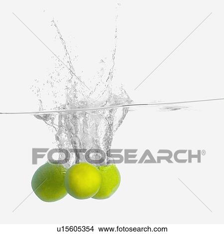 Picture - Close-up of three lemons underwater. Fotosearch