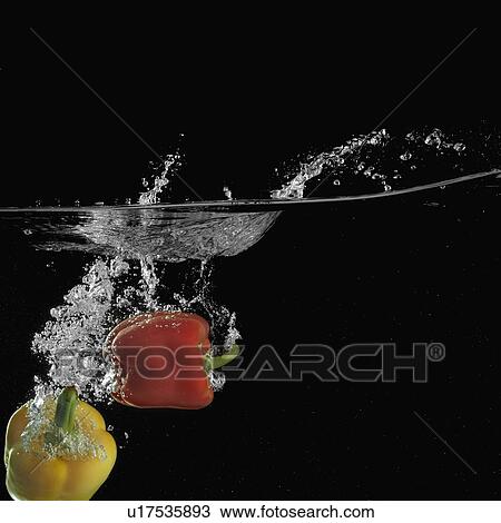 Stock Image - Close-up of two bell peppers underwater. Fotosearch
