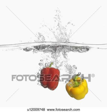 Stock Photo - Close-up of two bell peppers underwater. Fotosearch