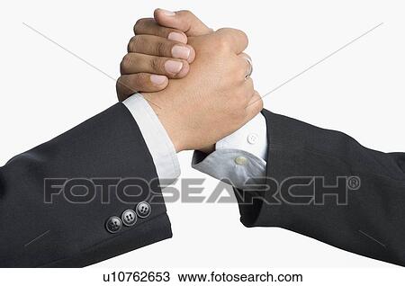 Stock Image - Close-up of two businessmen shaking hands. Fotosearch