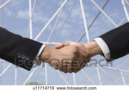 Stock Photo - Close-up of two businessmen shaking hands. Fotosearch