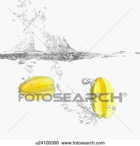 Stock Image - Close-up of two starfruits underwater. Fotosearch