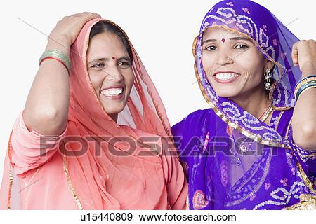 Stock Photo - Close-up of two young women smiling. Fotosearch