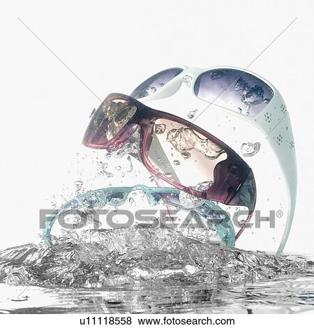 Stock Photo - Close-up of water splashing on sunglasses. Fotosearch
