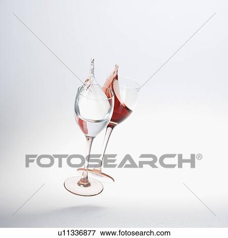 Stock Photo - Close-up of wine spilling from two wine glasses. Fotosearch