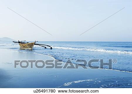 Stock Image - Fishing boat on the beach, Morjim Beach, Goa, India. Fotosearch