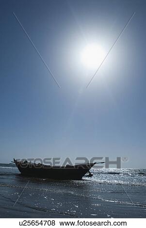 Stock Photo - Fishing boat on the beach, Morjim Beach, Goa, India. Fotosearch