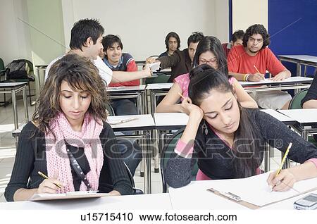 Group of college students giving an exam in a classroom View Large Photo Image Stock Image - Group of college students giving an exam in a classroom. Fotosearch