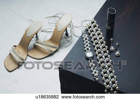 High angle view of a pair of sandals with a wristwatch and a bracelet View Large Photo Image Stock Image - High angle view of a pair of sandals with a wristwatch and a bracelet. Fotosearch