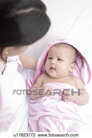 High angle view of a young woman holding her daughter View Large Photo Image Stock Image - High angle view of a young woman holding her daughter. Fotosearch