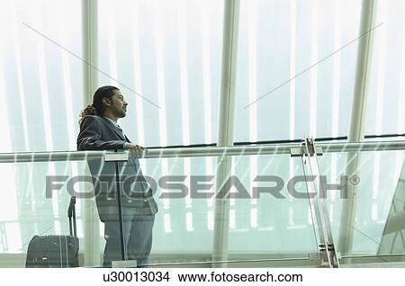 Low angle view of a businessman leaning against a railing View Large Photo Image Picture - Low angle view of a businessman leaning against a railing. Fotosearch