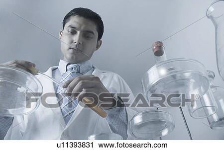 Stock Image - Low angle view of a male scientist working in a laboratory. Fotosearch