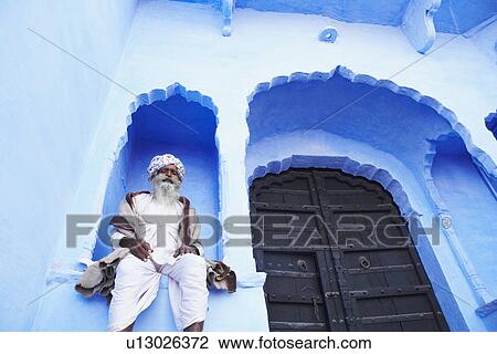 Low angle view of a senior man sitting on an arch window, Pushkar, Rajasthan, India View Large Photo Image Stock Image - Low angle view of a senior man sitting on an arch window, Pushkar, Rajasthan, India. Fotosearch