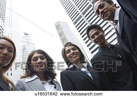 Low angle view of five business executives standing together View Large Photo Image Stock Image - Low angle view of five business executives standing together. Fotosearch