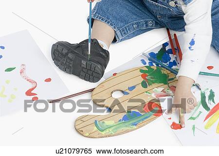 Low section view of a boy painting with a paintbrush View Large Photo Image Stock Photography - Low section view of a boy painting with a paintbrush. Fotosearch