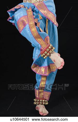 Stock Image - Low section view of a girl performing Bharatanatyam. Fotosearch