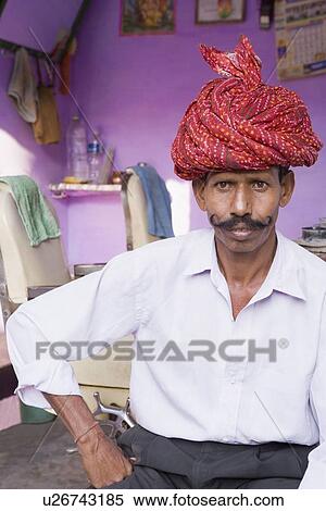 Stock Photography - Mature man sitting in a barber shop. Fotosearch