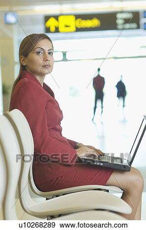 Stock Photo - Mid adult woman using a laptop. Fotosearch