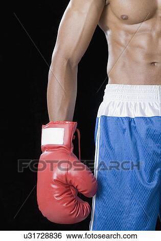 Stock Photograph - Mid section view of a boxer wearing a boxing glove. Fotosearch