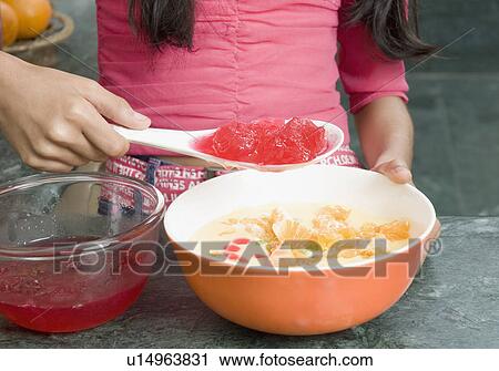 Mid section view of a girl making custard View Large Photo Image Stock Image - Mid section view of a girl making custard. Fotosearch