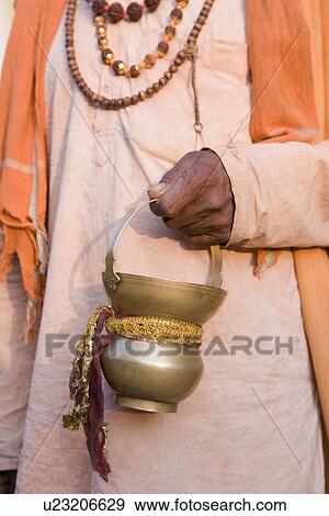 Mid section view of a sadhu holding a vase View Large Photo Image Stock Photo - Mid section view of a sadhu holding a vase. Fotosearch