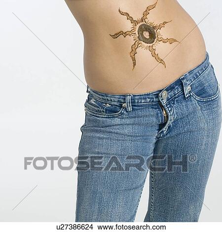 Mid section view of a woman with tattoo on her abdomen View Large Photo Image Picture - Mid section view of a woman with tattoo on her abdomen. Fotosearch