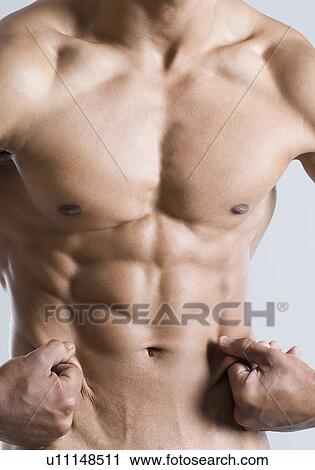 Mid section view of a young man showing his abdominal muscles View Large Photo Image Stock Image - Mid section view of a young man showing his abdominal muscles. Fotosearch