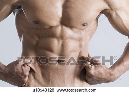 Stock Photo - Mid section view of a young man showing his abdominal muscles. Fotosearch