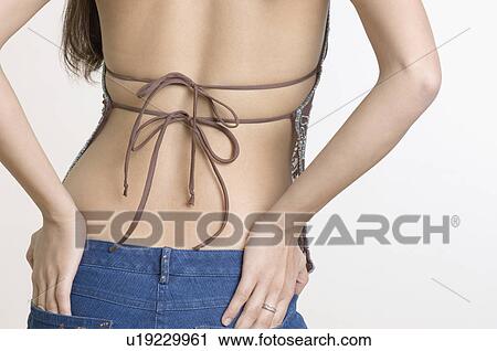 Mid section view of a young woman with her hands on her hips View Large Photo Image Stock Image - Mid section view of a young woman with her hands on her hips. Fotosearch