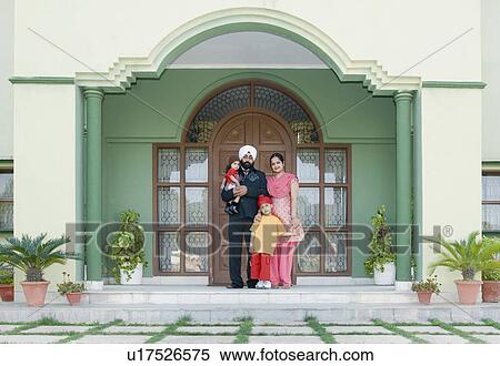 Parents standing with their son and daughter at a doorway View Large Photo Image Stock Photography - Parents standing with their son and daughter at a doorway. Fotosearch