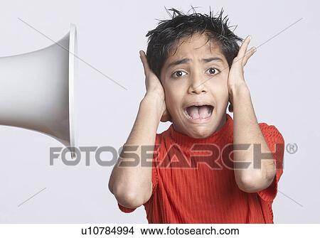 Portrait of a boy covering his ears with his hands View Large Photo Image Picture - Portrait of a boy covering his ears with his hands. Fotosearch
