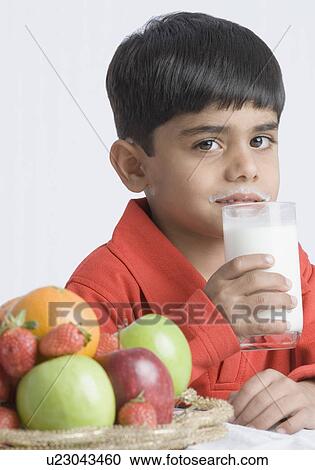 Portrait of a boy drinking a glass of milk View Large Photo Image Stock Image - Portrait of a boy drinking a glass of milk. Fotosearch