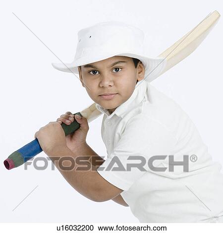 Stock Image - Portrait of a boy holding a cricket bat. Fotosearch