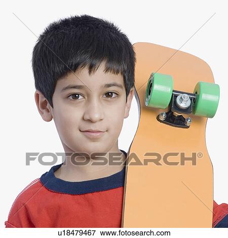 Portrait of a boy holding a skateboard View Large Photo Image Stock Photo - Portrait of a boy holding a skateboard. Fotosearch