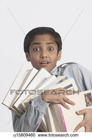 Portrait of a boy holding books View Large Photo Image Stock Image - Portrait of a boy holding books. Fotosearch