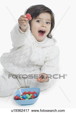 Portrait of a boy showing a plastic ball View Large Photo Image Stock Photo - Portrait of a boy showing a plastic ball. Fotosearch