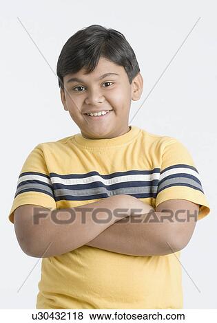 Portrait of a boy smiling with his arms crossed View Large Photo Image Stock Photo - Portrait of a boy smiling with his arms crossed. Fotosearch