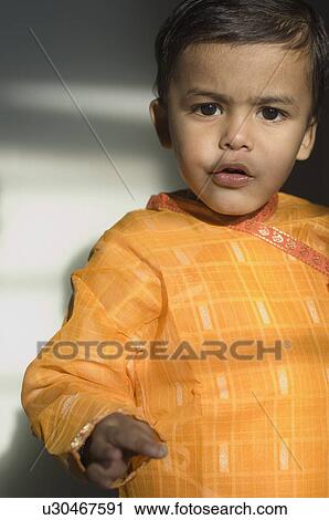 Stock Image - Portrait of a boy standing. Fotosearch