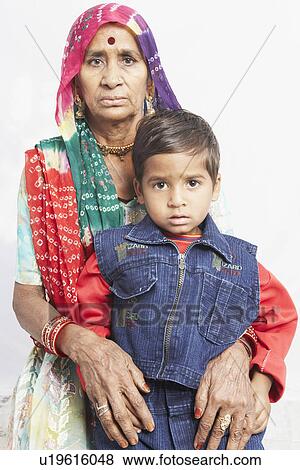 Stock Photo - Portrait of a boy standing with his grandmother. Fotosearch