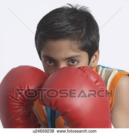 Stock Photo - Portrait of a boy wearing a boxing glove. Fotosearch