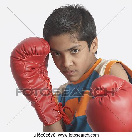 Stock Photo - Portrait of a boy wearing boxing gloves. Fotosearch