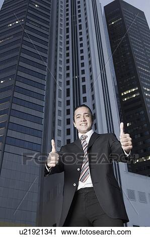 Portrait of a businessman showing thumbs up sign and smiling View Large Photo Image Stock Image - Portrait of a businessman showing thumbs up sign and smiling. Fotosearch