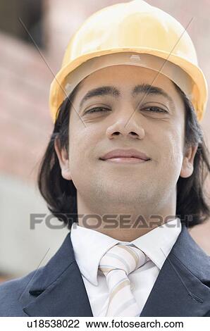 Portrait of a businessman wearing a hardhat View Large Photo Image Stock Image - Portrait of a businessman wearing a hardhat. Fotosearch
