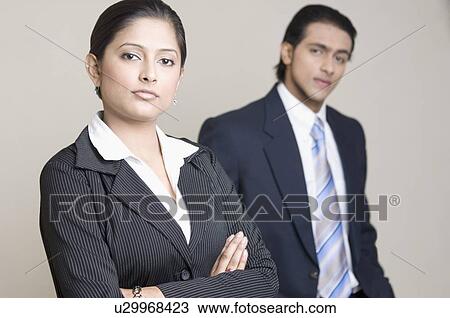 Stock Image - Portrait of a businesswoman and a businessman looking confident. Fotosearch