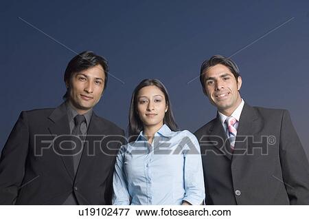 Portrait of a businesswoman and two businessmen standing together View Large Photo Image Stock Photo - Portrait of a businesswoman and two businessmen standing together. Fotosearch