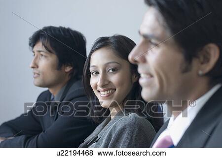 Portrait of a businesswoman and two businessmen smiling View Large Photo Image Stock Photo - Portrait of a businesswoman and two businessmen smiling. Fotosearch