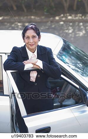Portrait of a businesswoman getting off a car View Large Photo Image Stock Image - Portrait of a businesswoman getting off a car. Fotosearch